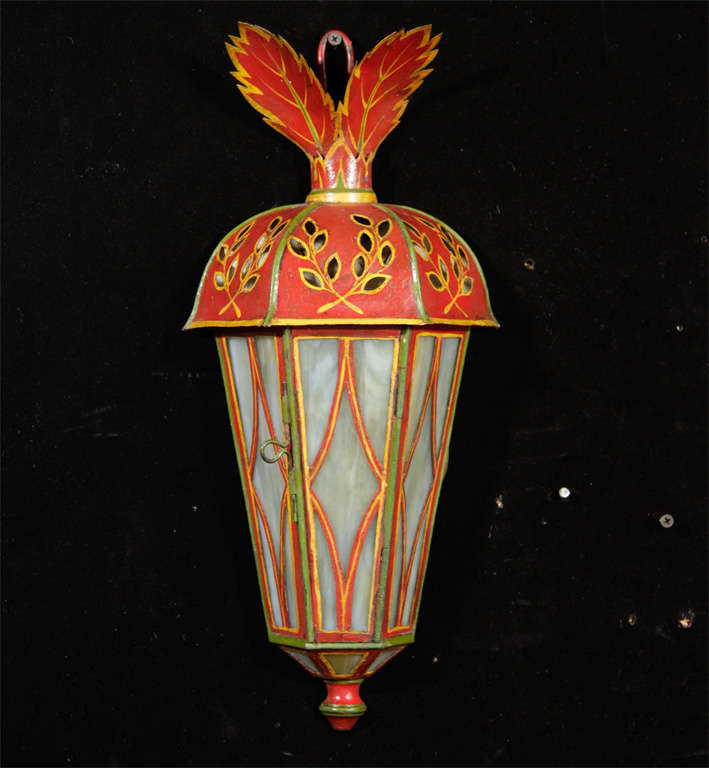 Pair of polychromed decorated fret work tole wall lanterns with slag glass panels.